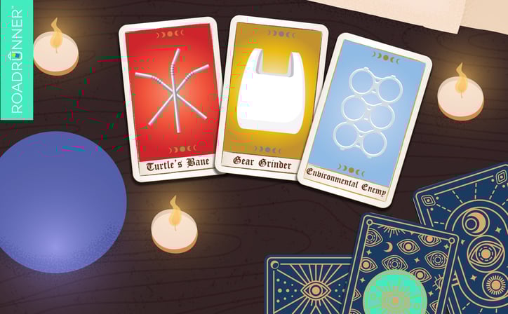 A crystal ball and candles next to three tarot cards with plastic straws, a plastic bag, and plastic six-pack ring.