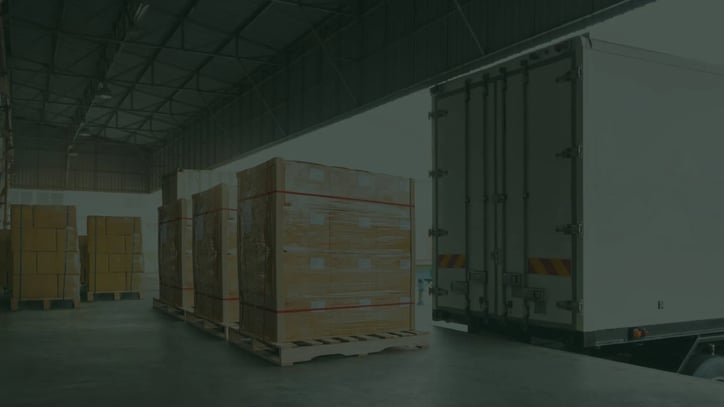 Hand pallet truck and the shipment pallet at the dock for loading into a truck
