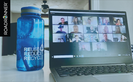 a plastic bottle next to a computer hosting a video call