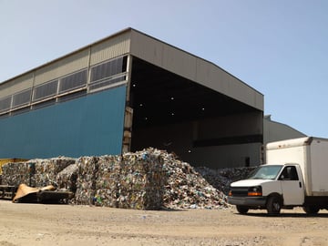 A box truck entering a recycling center facility.