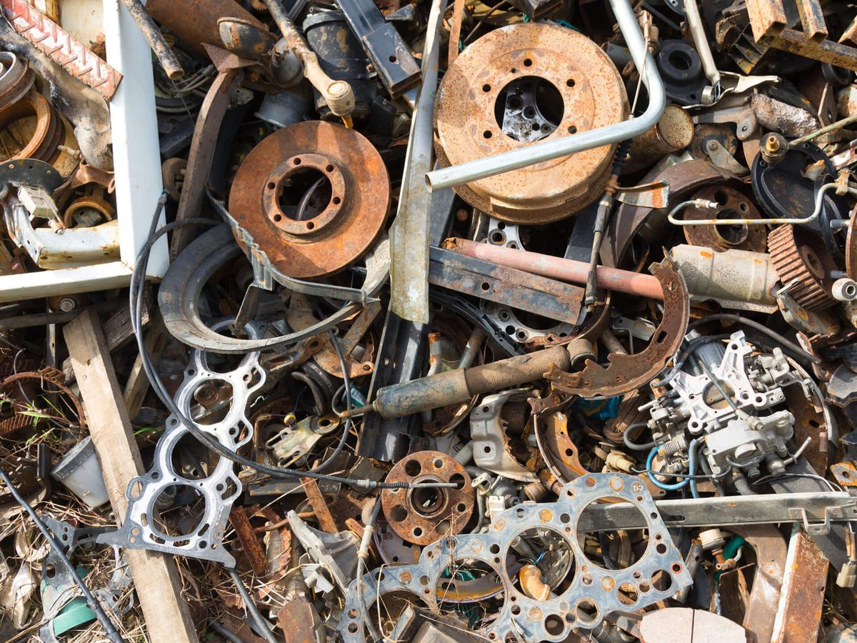 a scrapyard containing automative pieces and parts