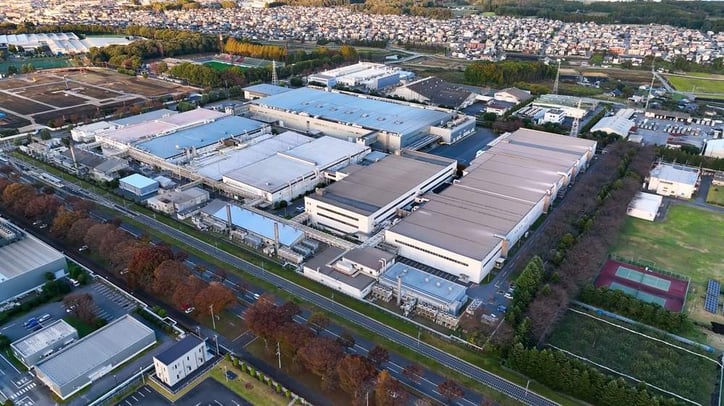 Aerial view of multiple factories across an industrial area managed as one facility portfolio.