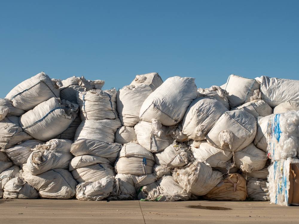 A large pile of plastic waste bales.